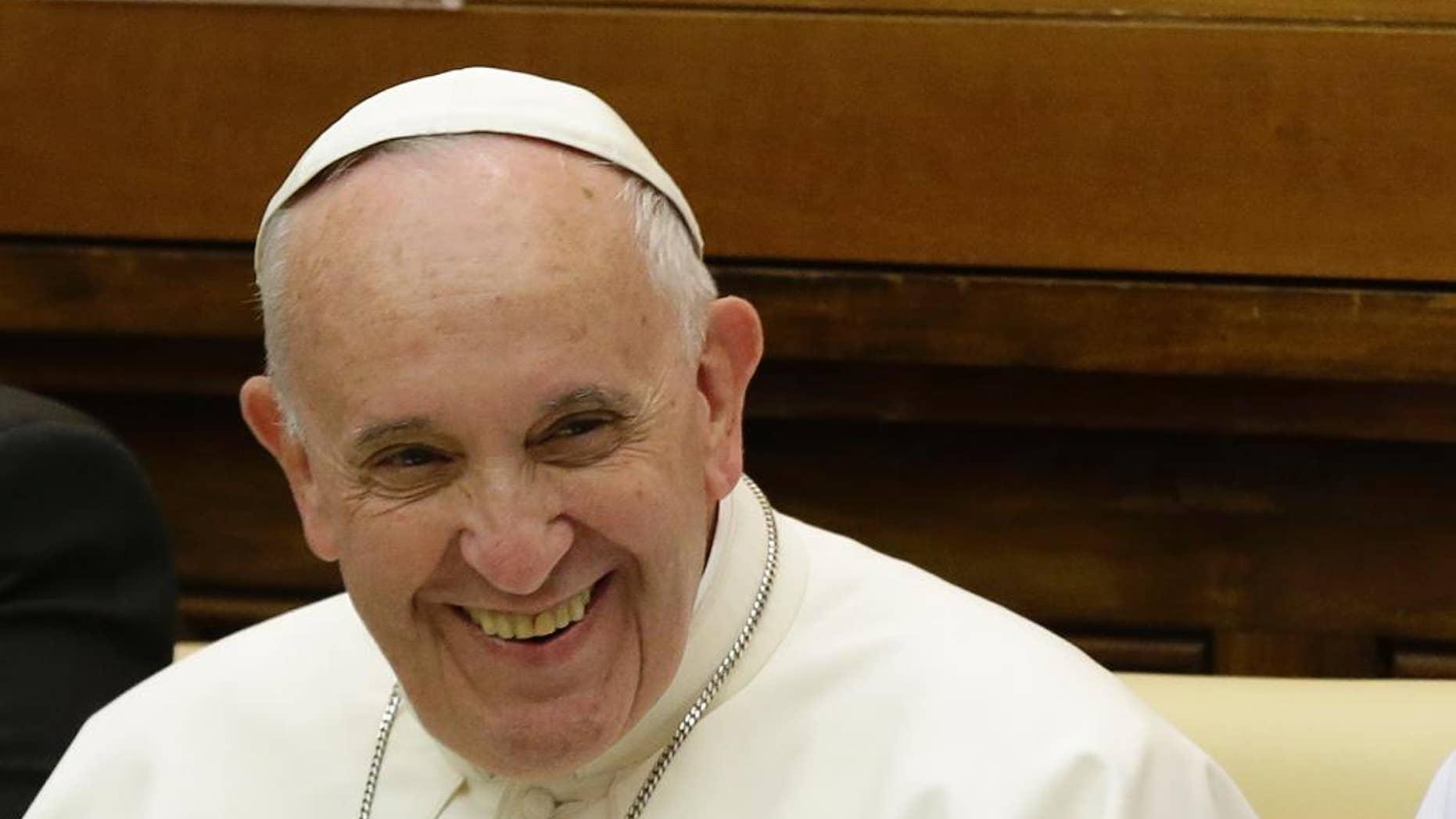 Pope Francis smiles as he arrives to attend a two-day summit of judges and magistrates against human trafficking and organized crime, at the Vatican, Friday, June 3, 2016. Judges and prosecutors from around the world are pledging to crack down on human trafficking and help victims of modern-day slavery in the latest Vatican initiative to draw attention to the problem and rally resources to fight it. (AP Photo/Gregorio Borgia)