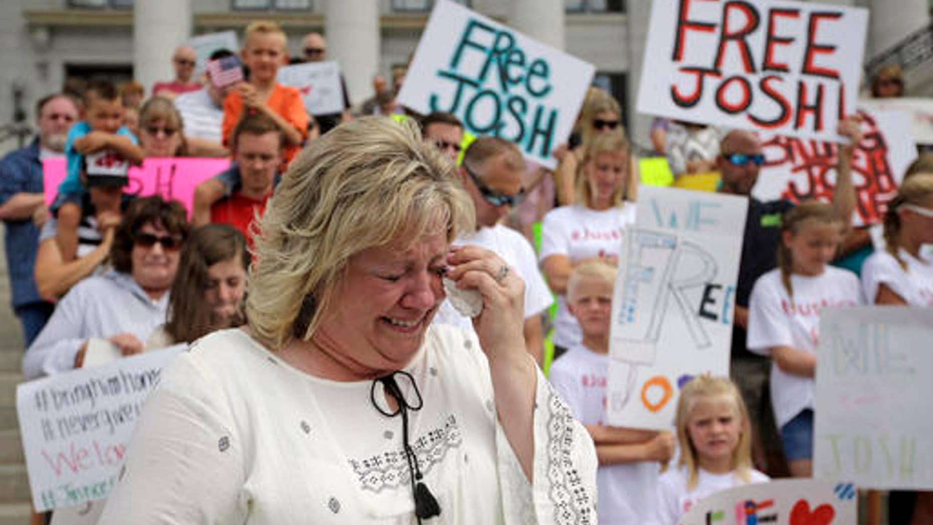 Laurie Holt, mother of Josh Holt, cries during a rally at the Utah State Capitol on July 30, 2016.