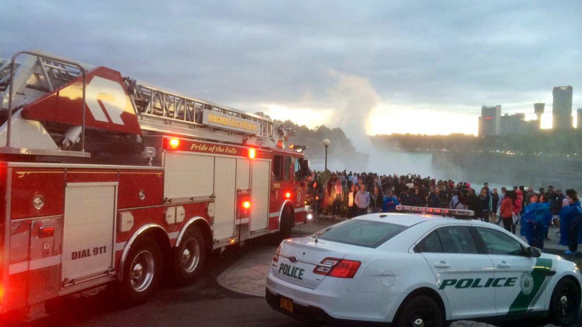 In this photo provided by WIVB, a crowd gathers near where someone reportedly went over the American Falls in Niagara Falls, N.Y., Saturday, Sept. 19, 2015. (WIVB via AP) MANDATORY CREDIT