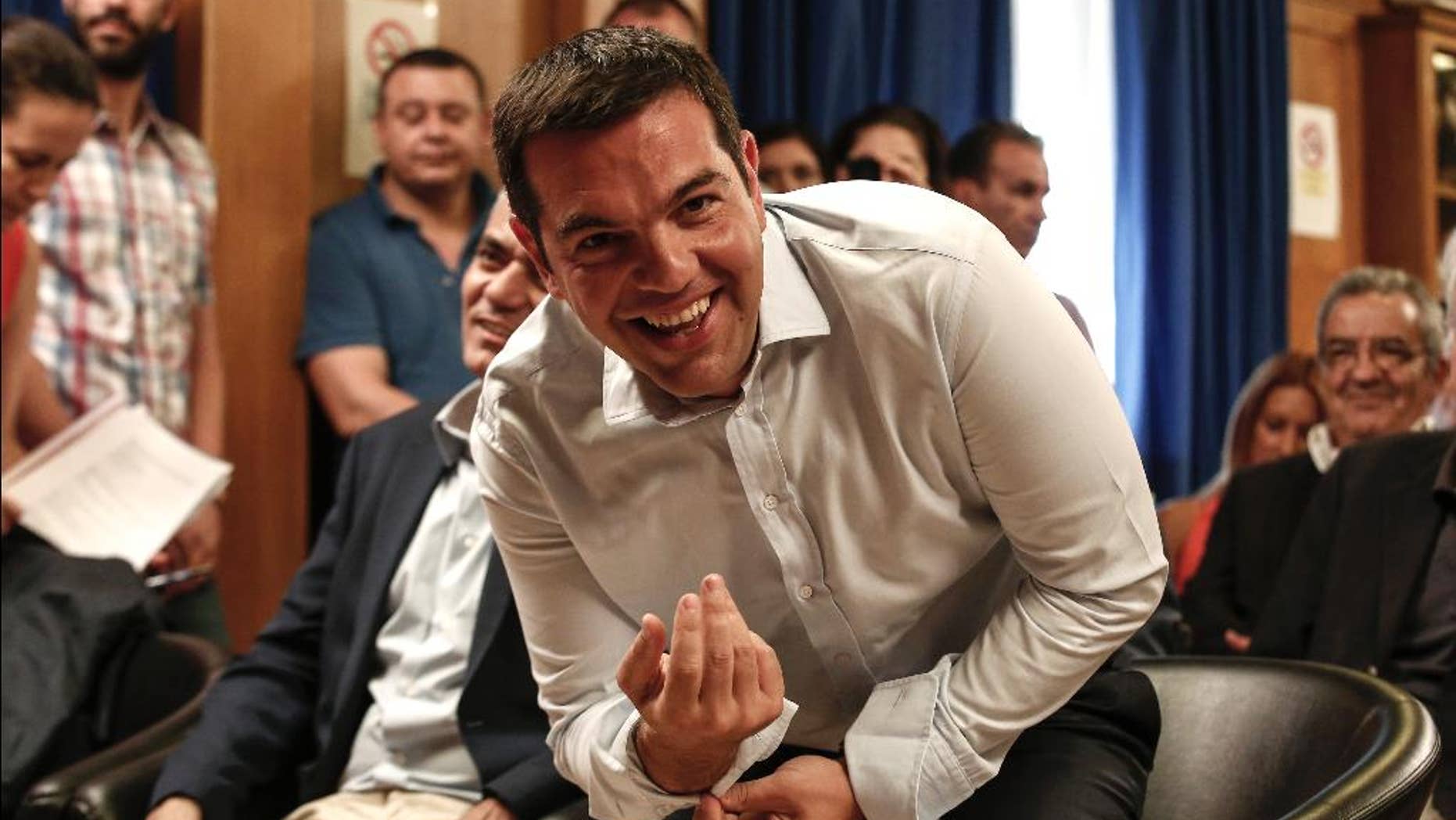 Greece's Prime minister Alexis Tsipras takes his seat to attend a gathering at the Agriculture ministry in Athens, Greece, on Wednesday, Aug. 5, 2015. Tsipras said his country was at the “final stage” of talks for a new bailout, as his left-wing government on Wednesday rejected the idea of an extension in negotiations. (AP Photo/Yorgos Karahalis)