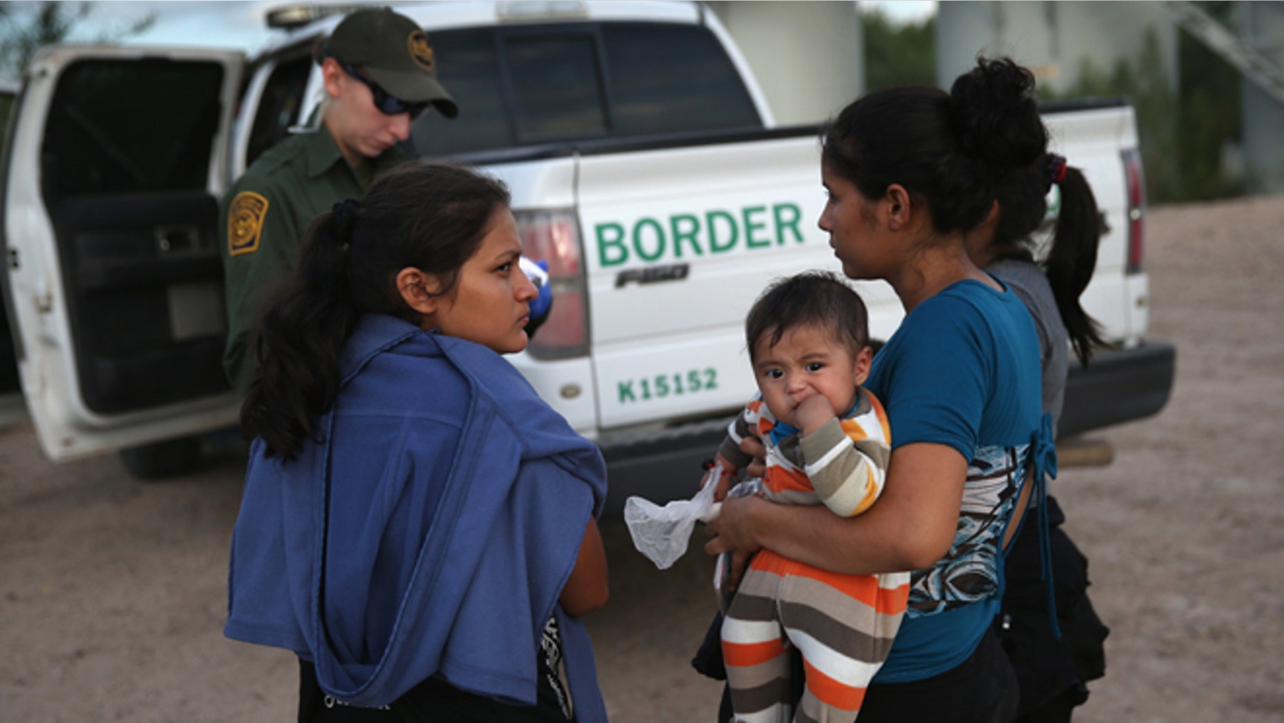 MCALLEN, TX - SEPTEMBER 08: Families of Central American immigrants turn themselves in to U.S. Border Patrol agents after crossing the Rio Grande River from Mexico on September 8, 2014 to McAllen, Texas. Although the numbers of such immigrant families and unaccompanied minors have decreased from a springtime high, thousands continue to cross in the border illegally into the United States. The Rio Grande Valley sector is the busiest area for illegal border crossings, especially for Central Americans, into the U.S. (Photo by John Moore/Getty Images)