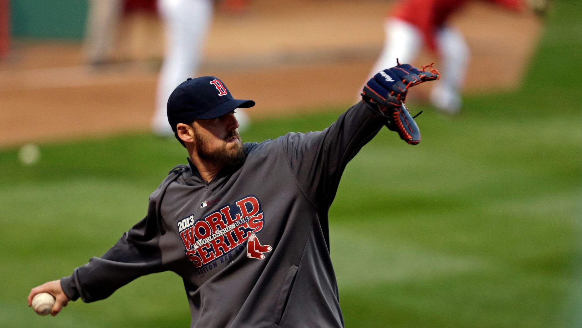 Boston Red Sox pitcher John Lackey throws during a baseball workout Tuesday, Oct. 22, 2013, in Boston. The Red Sox are scheduled to host the St. Louis Cardinals in Game 1 of baseball's World Series on Wednesday. (AP Photo/Charles Krupa)