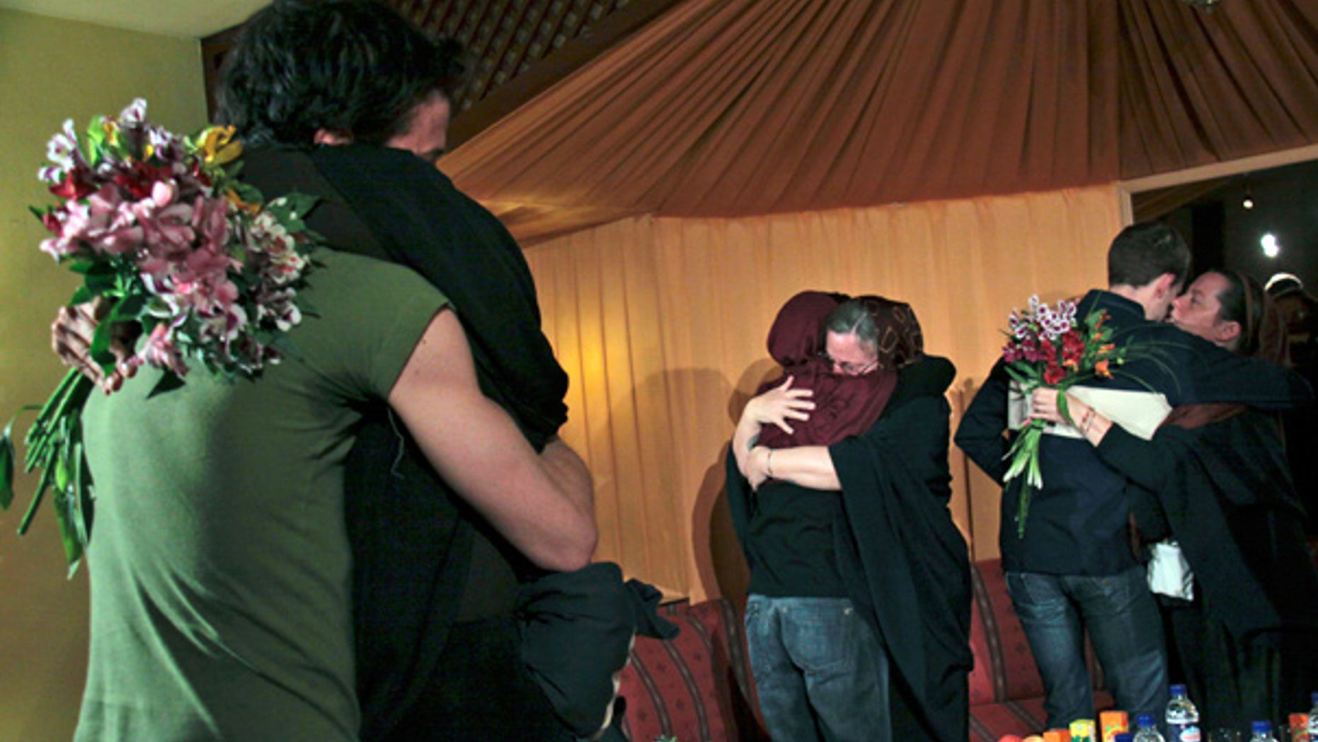 May 20: The mothers of 3 Americans detained in Iran hug their children at the Esteghlal hotel in Tehran.