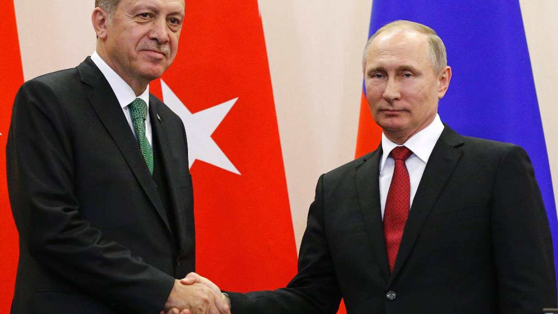 Russian President Vladimir Putin, right, and Turkish President Recep Tayyip Erdogan shake hands after a news conference following their talks in Putin's residence in the Russian Black Sea resort of Sochi, Russia, Wednesday, May 3, 2017. The presidents of Russia and Turkey are holding talks on the situation in Syria and also the restoration of full economic ties between their two countries. (AP Photo/Alexander Zemlianichenko, Pool)