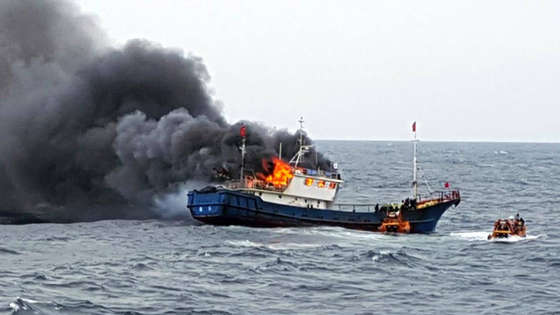 In this Thursday, Sept. 29, 2016 photo provided by the South Korean Mokpo Coast Guard, a Chinese fishing boat catches fires during an inspection by the South Korean coast guard in the water off Hong Island, South Korea. South Korea’s coast guard said three Chinese fishermen have been found dead when a fire broke out on their boat after the coast guard fired a flashbang grenade at the vessel to stop it. (South Korean Mokpo Coast Guard via AP)