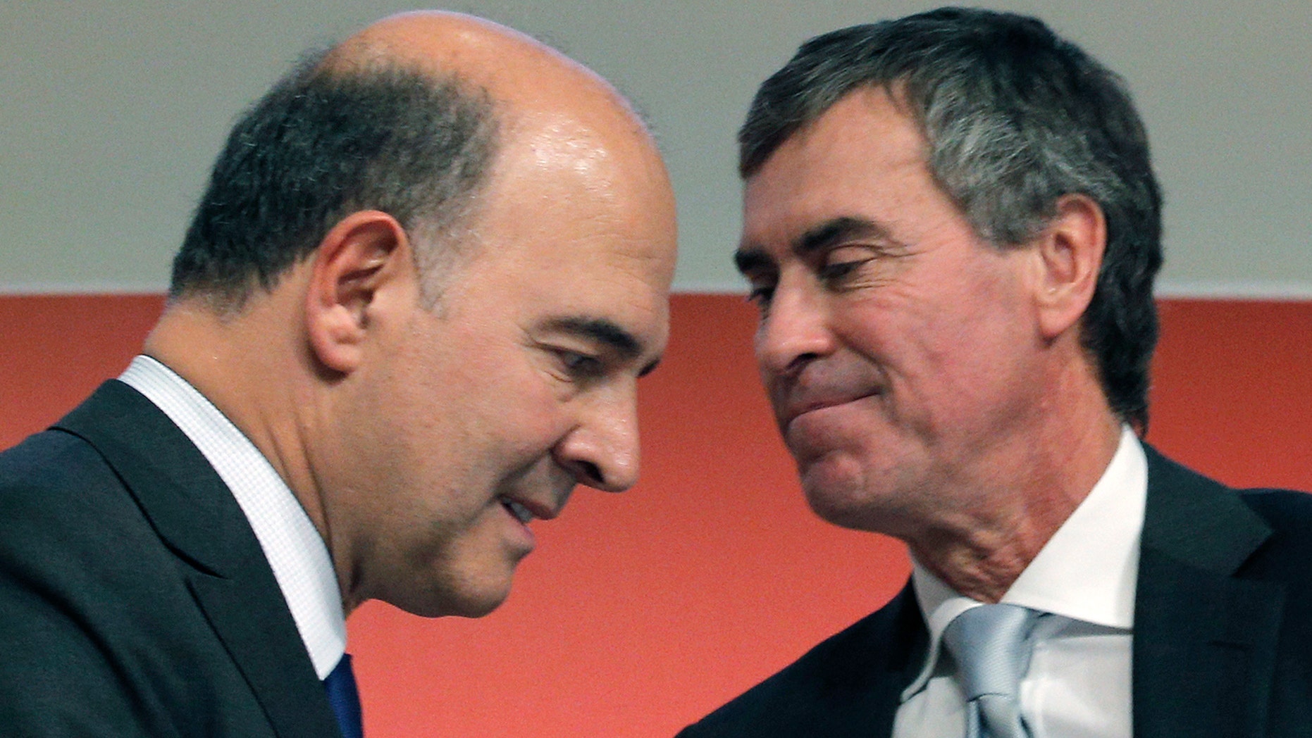 FILE - In this Sept. 28, 2012 file photo, France's Finance Minister Pierre Moscovici, left, and then Budget Minister Jerome Cahuzac attend a press conference in Paris. Francois Hollande is a President on the ropes, reeling from a potentially knockout blow delivered by his ex-budget minister, a man who admitted this week that he had hidden hundreds of thousands of euros from the taxman for decades and lied about it. Those lies from Jerome Cahuzac came both in front of the National Assembly and to Hollande's own face. (AP Photo/Christophe Ena, File)