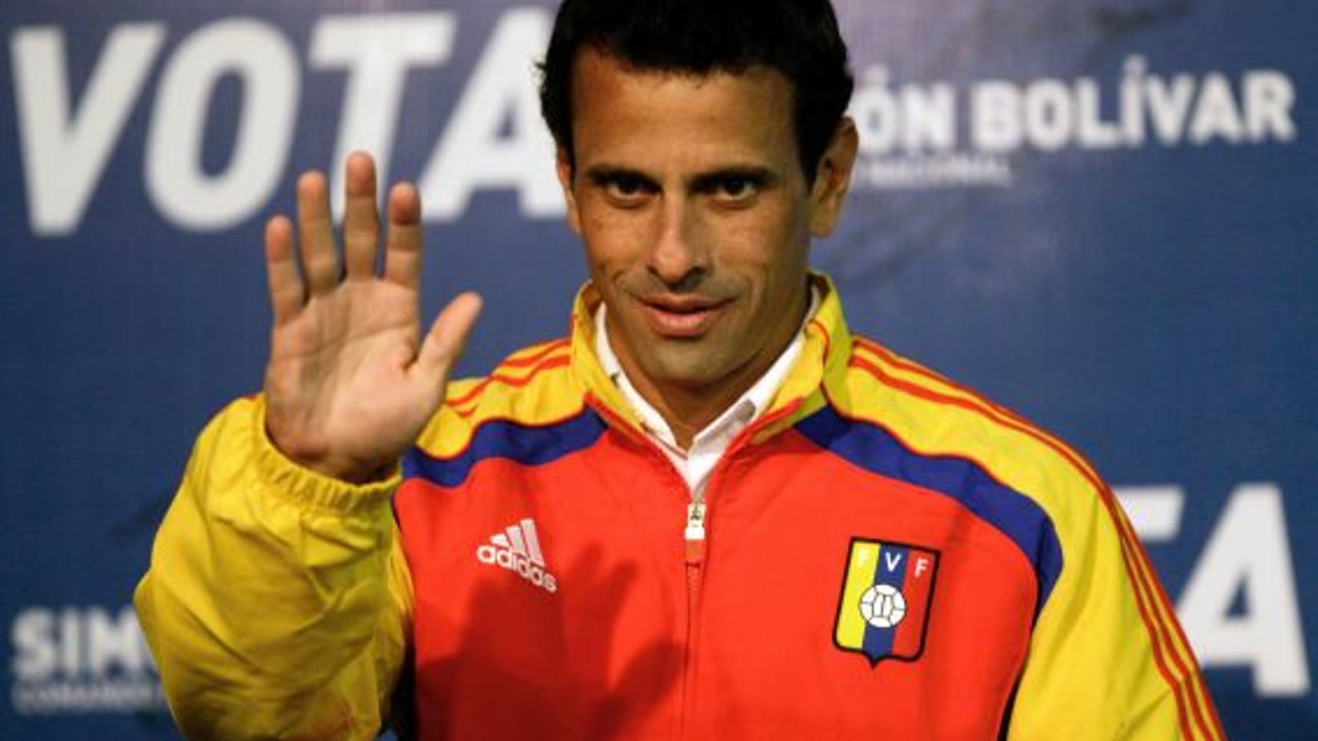 April 13, 2013: Opposition presidential candidate Henrique Capriles waves as he arrives to a news conference in Caracas, Venezuela.