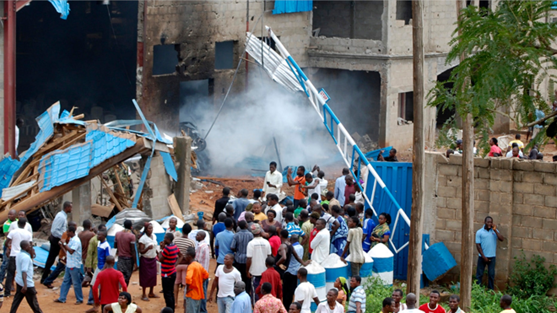 June 17, 2012: People gather outside a church following a blast in Kaduna, Nigeria.