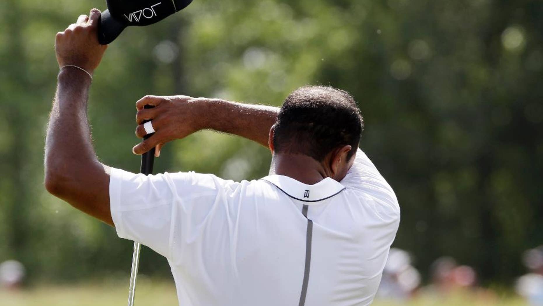 Tiger Woods wipes his head on the sixth hole during the second round of the PGA Championship golf tournament Friday, Aug. 14, 2015, at Whistling Straits in Haven, Wis. (AP Photo/Brynn Anderson)