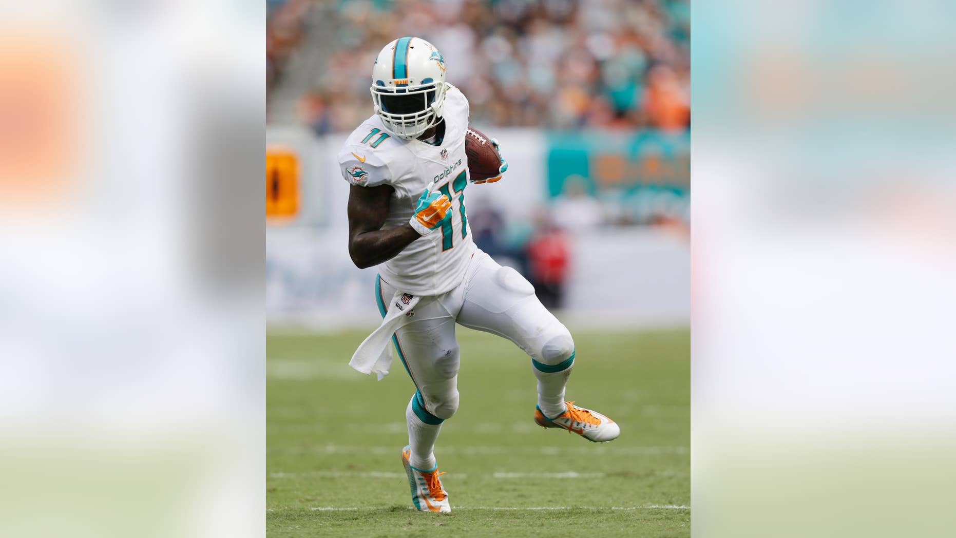 FILE - In this Sunday Sept. 7, 2014 file photo, Miami Dolphins wide receiver Mike Wallace (11) runs for a touchdown during the second half of an NFL football game against the New England Patriots, in Miami Gardens, Fla. Mike Wallace is still stewing about the Miami Dolphins' latest sputtering offensive performance. Wallace said Tuesday, Oct. 28, 2014 he can't identify the problem, but added progress needs to come quickly because the Dolphins face several high-scoring teams in the next month, starting with San Diego on Sunday. (AP Photo/Wilfredo Lee, File)