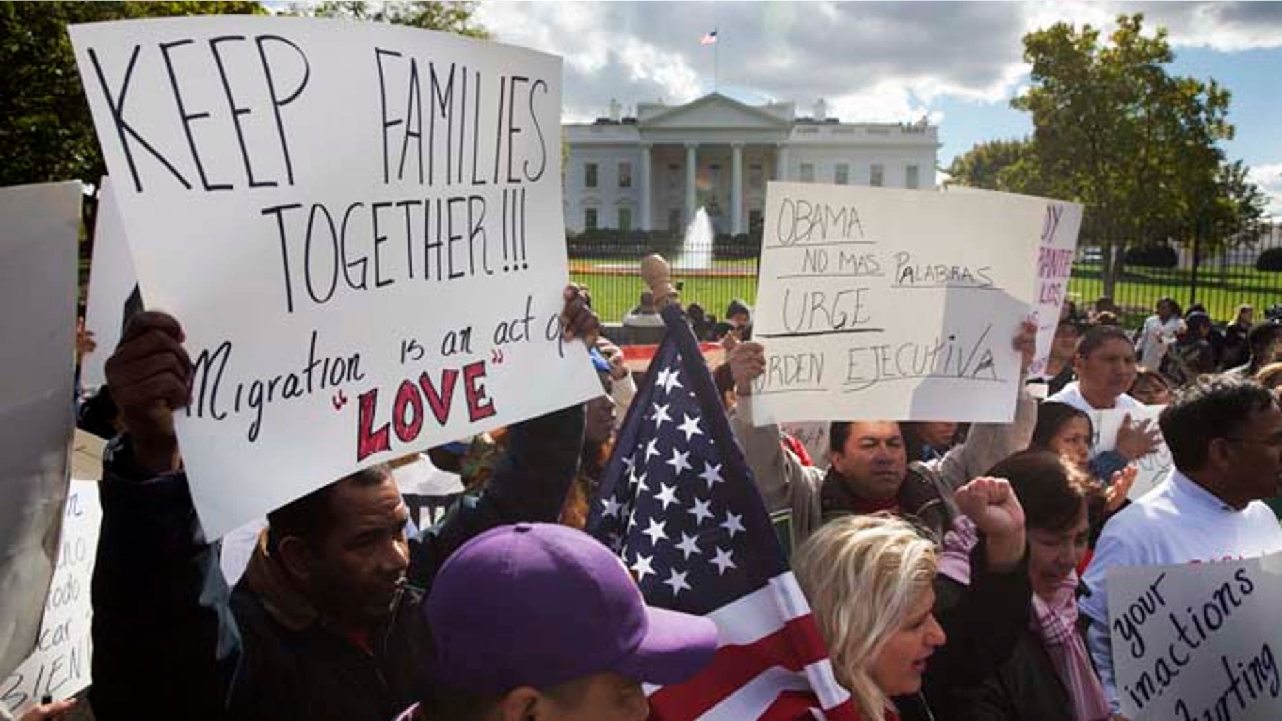 In this Nov. 7, 2014 file photo, people rally for comprehensive immigration reform outside the White House in Washington.