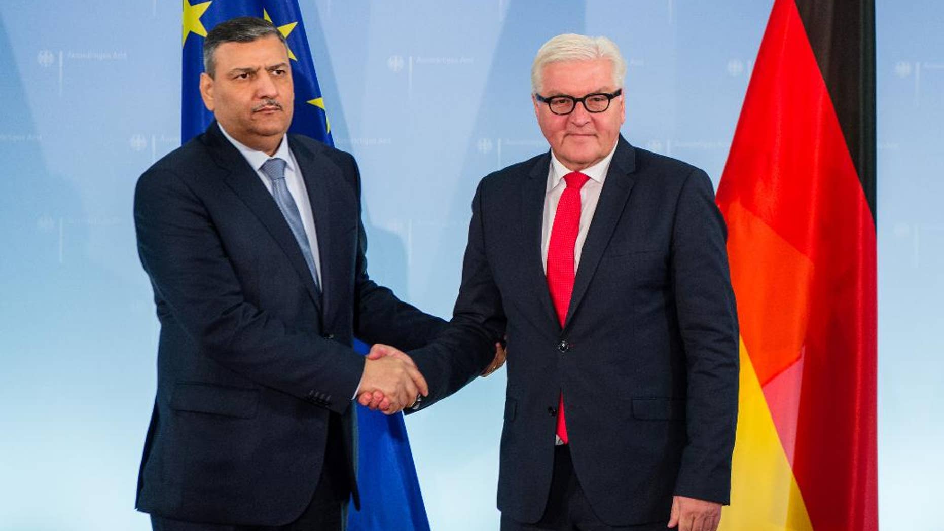 Former Syrian Prime Minister Dr Riyad Farid Hijab, now coordinator of the High Negotiations Committee of the Syrian Opposition (HNC) , left, shakes hands with German foreign minister Frank-Walter Steinmeier during their meeting in Berlin, Thursday Nov. 3, 2016. (Sebastian Gollnow/dpa via AP)