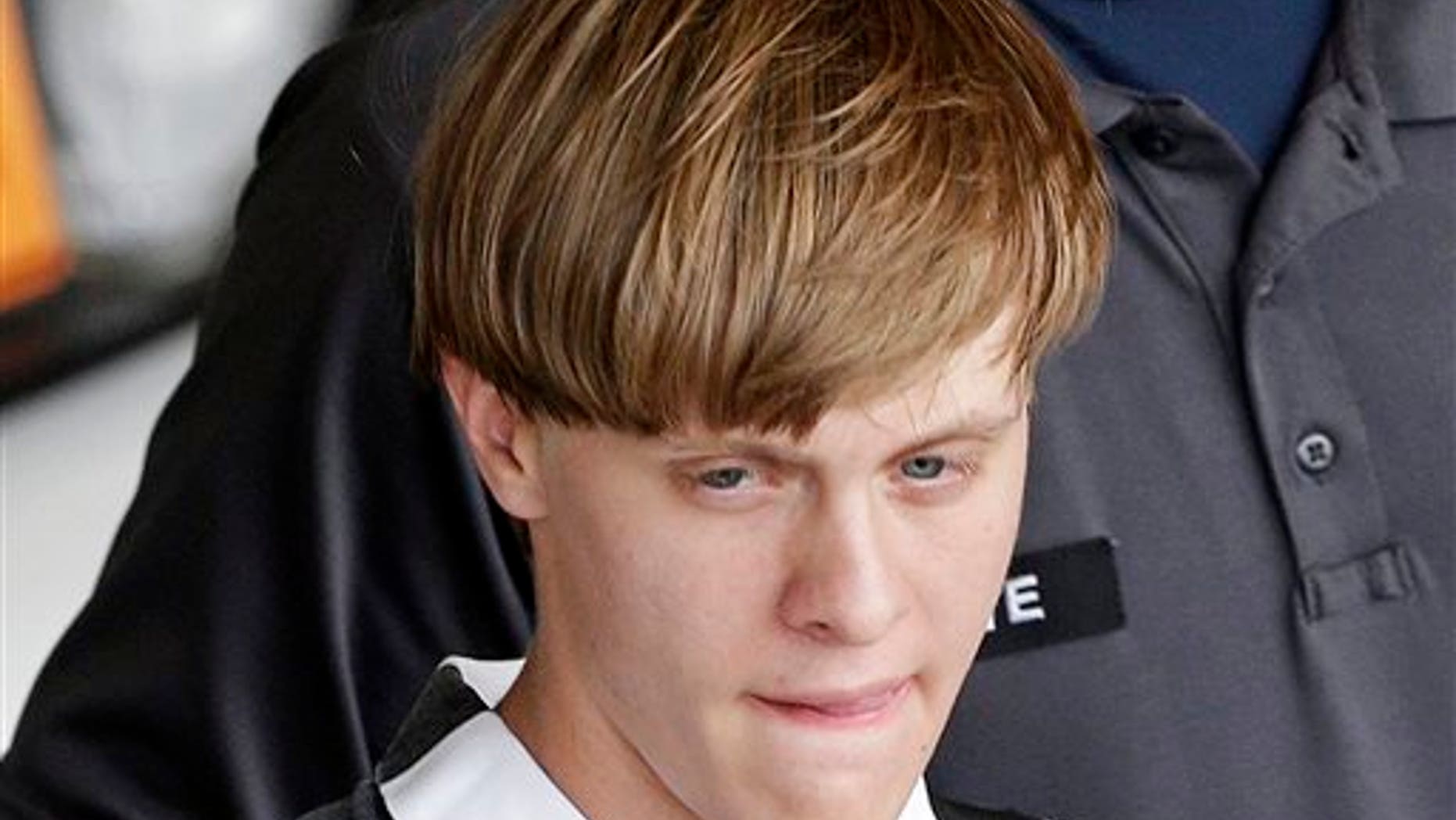 Charleston, S.C., shooting suspect Dylann Roof is escorted from the Cleveland County Courthouse in Shelby, N.C., Thursday, June 18, 2015. (AP Photo/Chuck Burton)