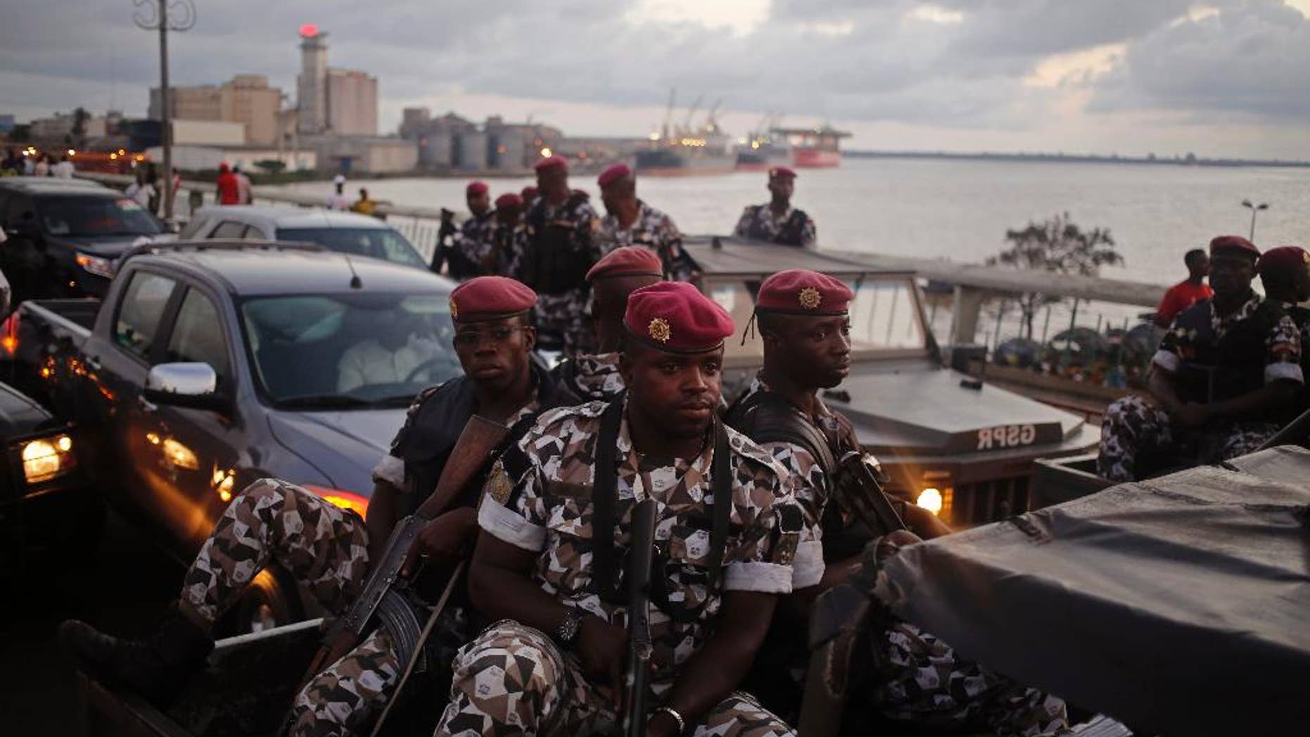 FILE-In this file photo taken Friday, Oct. 23, 2015, Ivory Coast troops provide security during an election rally of Ivory Coast incumbent President Alassane Ouattara in Abidjan, Ivory Coast. Some unidentified soldiers have launched mutinies in three cities across this West African country on Friday, Jan. 6, 2017, demanding higher pay and bringing the threat of unrest back to Africa's fastest-growing economy, authorities said. (AP Photo/Schalk van Zuydam, File)