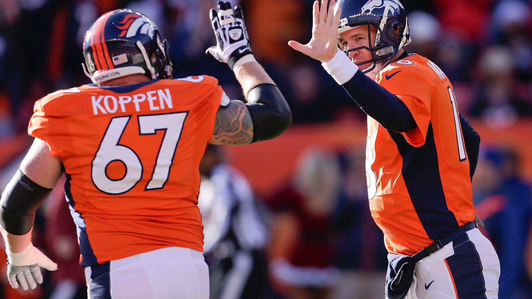 Denver Broncos quarterback Peyton Manning (18) gets a high five from Denver Broncos center Dan Koppen (67) after Manning threw a touchdown pass against the Cleveland Browns in the first quarter of an NFL football game, Sunday, Dec. 23, 2012, in Denver. (AP Photo/Joe Mahoney)