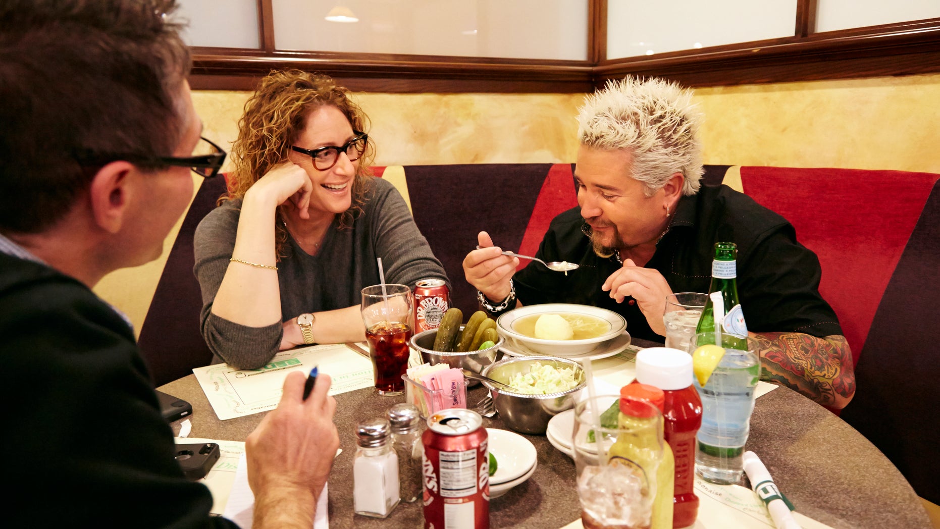 Dec. 9, 2013: Food Network star Guy Fieri, right, tasting matzo ball soup at Ben's Deli as comedian Judy Gold, center, and AP Food Editor J.M Hirsch look on.