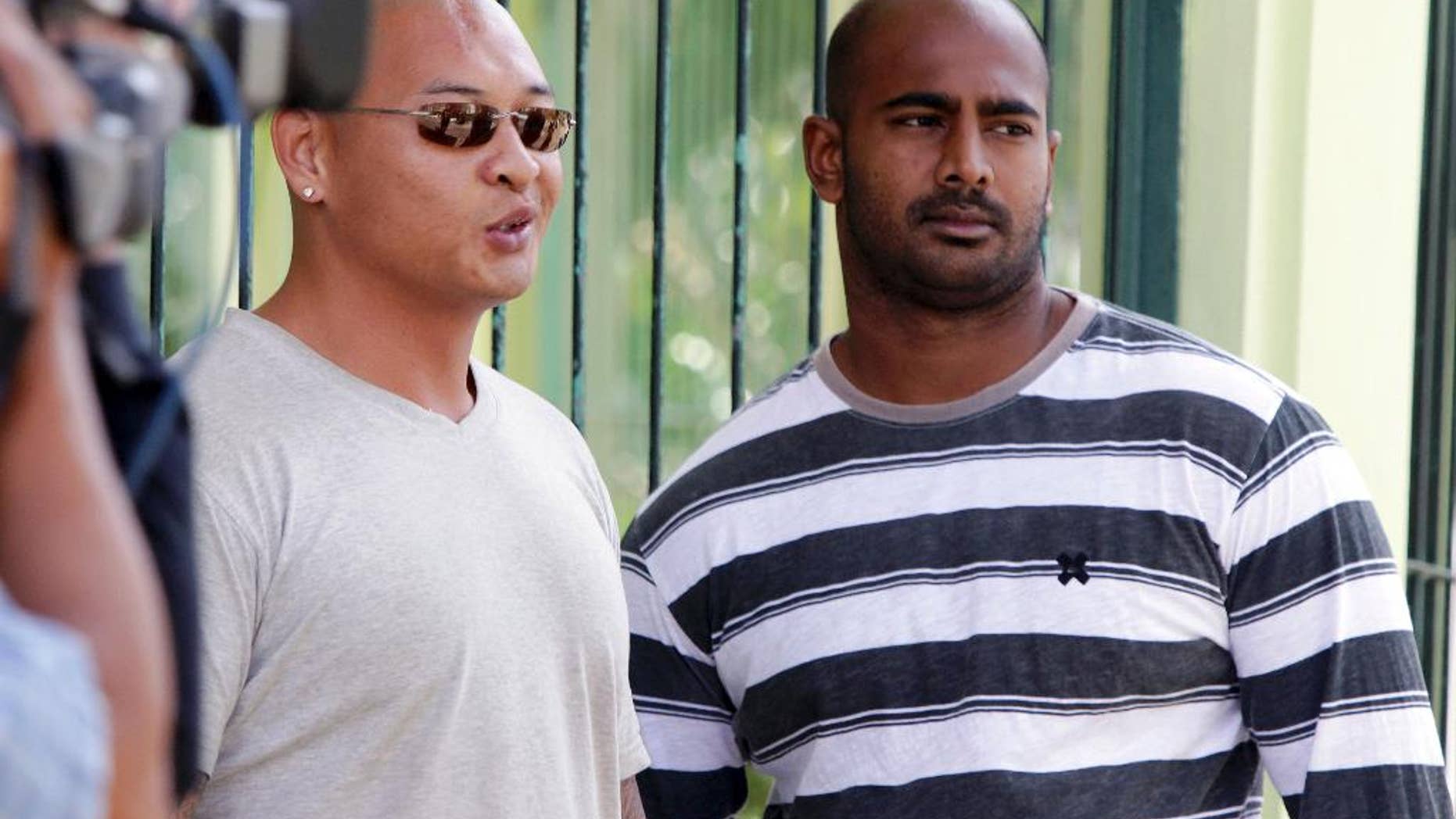 FILE - In this Aug. 17, 2011 file photo, Australian death-row prisoners Myuran Sukumaran, right and Andrew Chan, left, stand in front of their cell during an Indonesian Independence Day celebration at Kerobokan prison in Bali, Indonesia. Australia's Foreign Minister Julie Bishop on Thursday, Feb. 12, 2015 called on the Indonesian government to show the same mercy to two Australian drug traffickers on death row as Indonesia seeks from countries where Indonesian citizens face execution. (AP Photo/Firdia Lisnawati, File)