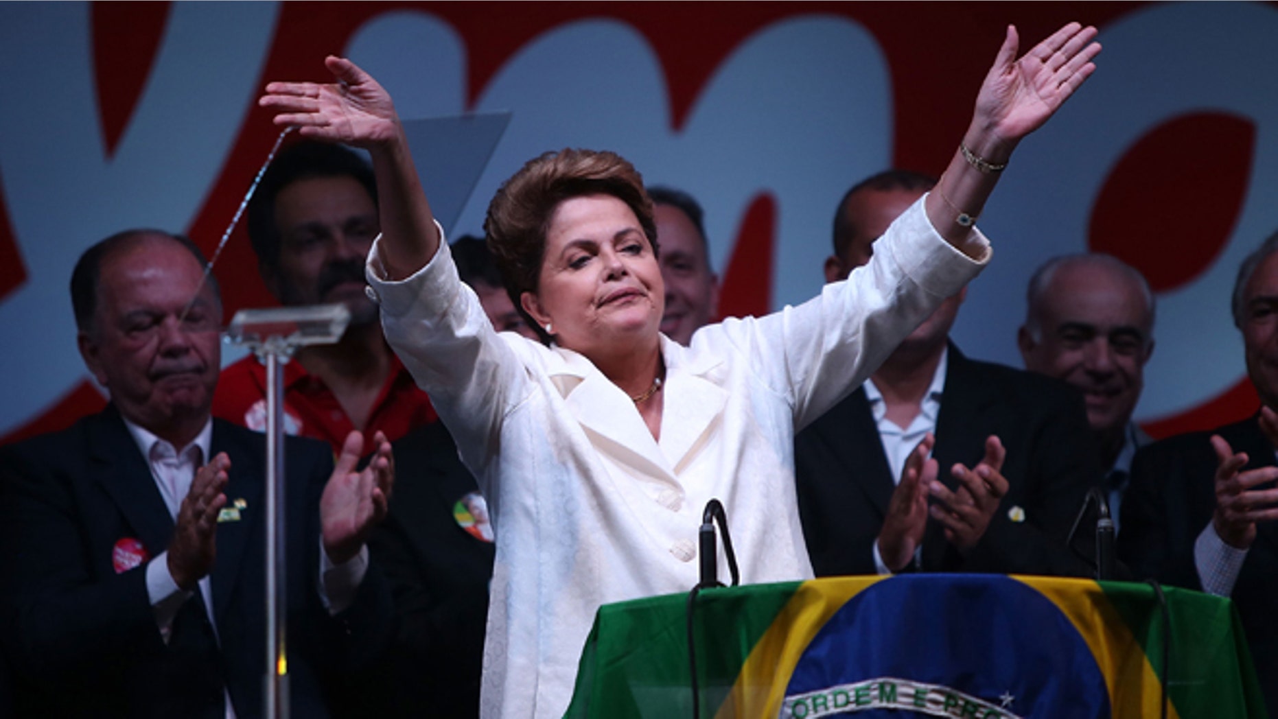BRASILIA, BRAZIL - OCTOBER 26: Brazilian President and Workers' Party (PT) candidate Dilma Rousseff (C) celebrates with Brazil's former president Luiz Inacio Lula Da Silva (R) after being re-elected on October 26, 2014 in Brasilia, Brazil. Rousseff defated Presidential candidate of the Brazilian Social Democratic Party (PSDB) Aecio Neves in a run-off election. (Photo by Mario Tama/Getty Images)