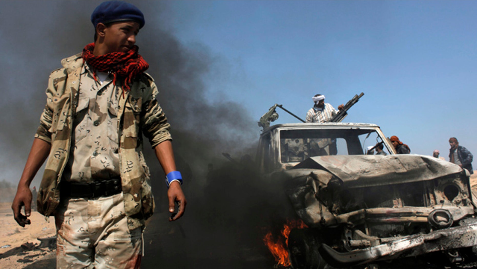 April 5: Libyan rebels inspect two destroyed military vehicles of pro-Qaddafi forces that rebels claim were targeted by a NATO strike along the front line near Brega, Libya.