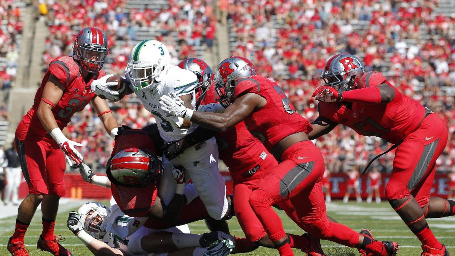 Tulane running back Sherman Badie (3) is tackled by Rutgers defenders L.J. Liston, Jonathan Aiken and others short of the end zone during the first half of an NCAA college football game, Saturday, Sept. 27, 2014, in Piscataway, N.J. Rutgers defeated Tulane 31-6. (AP Photo/Rich Schultz)