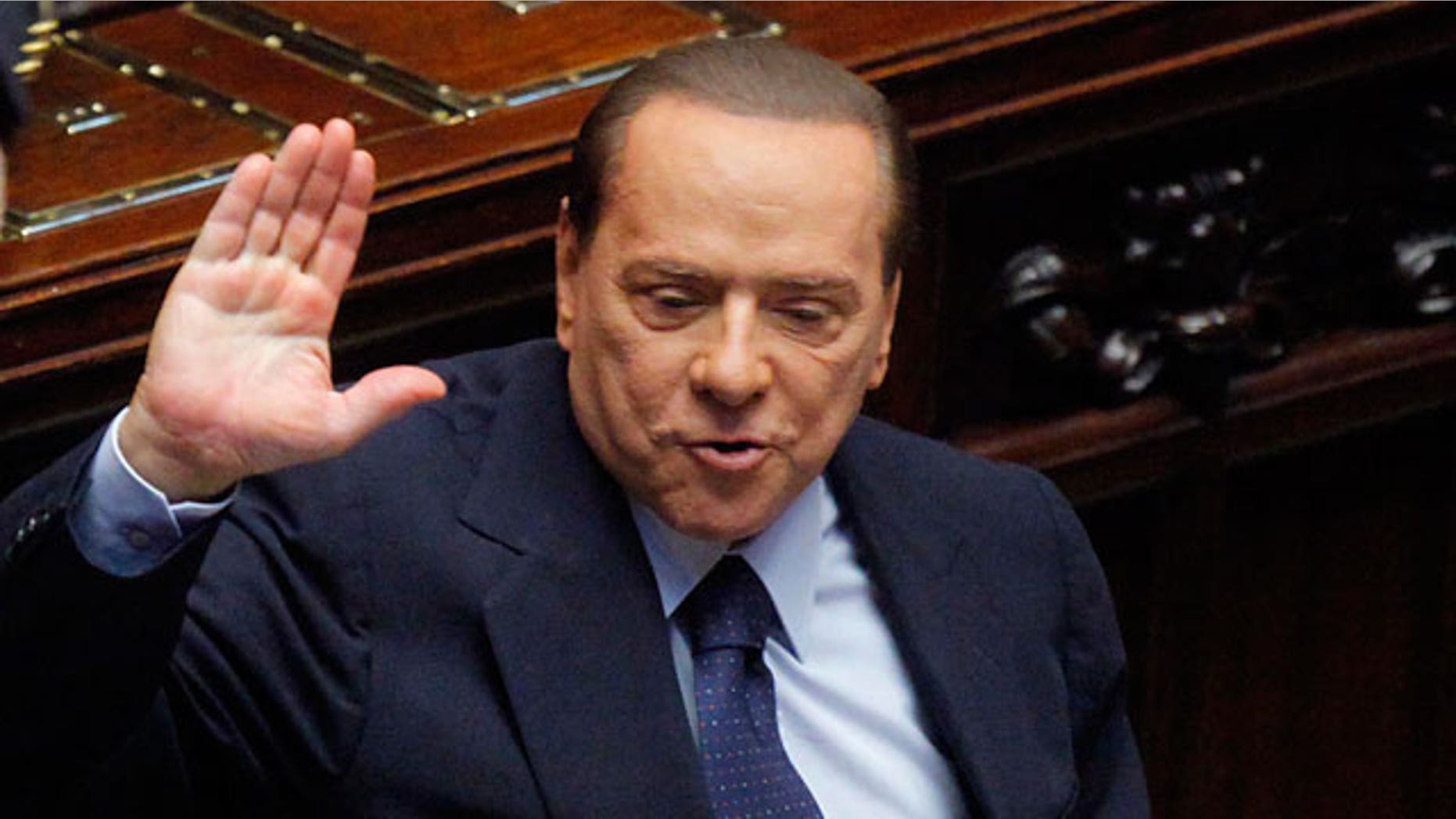 Italian Premier Silvio Berlusconi gestures in the Lower Chamber, in Rome, Friday, Oct. 14, 2011.