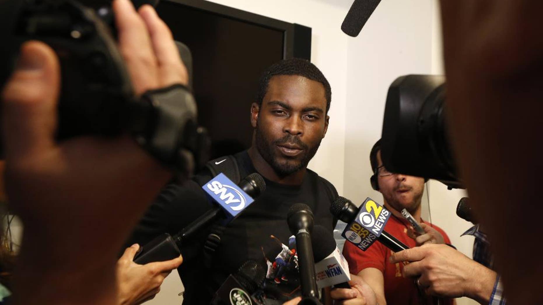 New York Jets quarterback Michael Vick talks to reporters during an NFL football organized team activity, Wednesday, May 28, 2014, in Florham Park, N.J. (AP Photo/Julio Cortez)