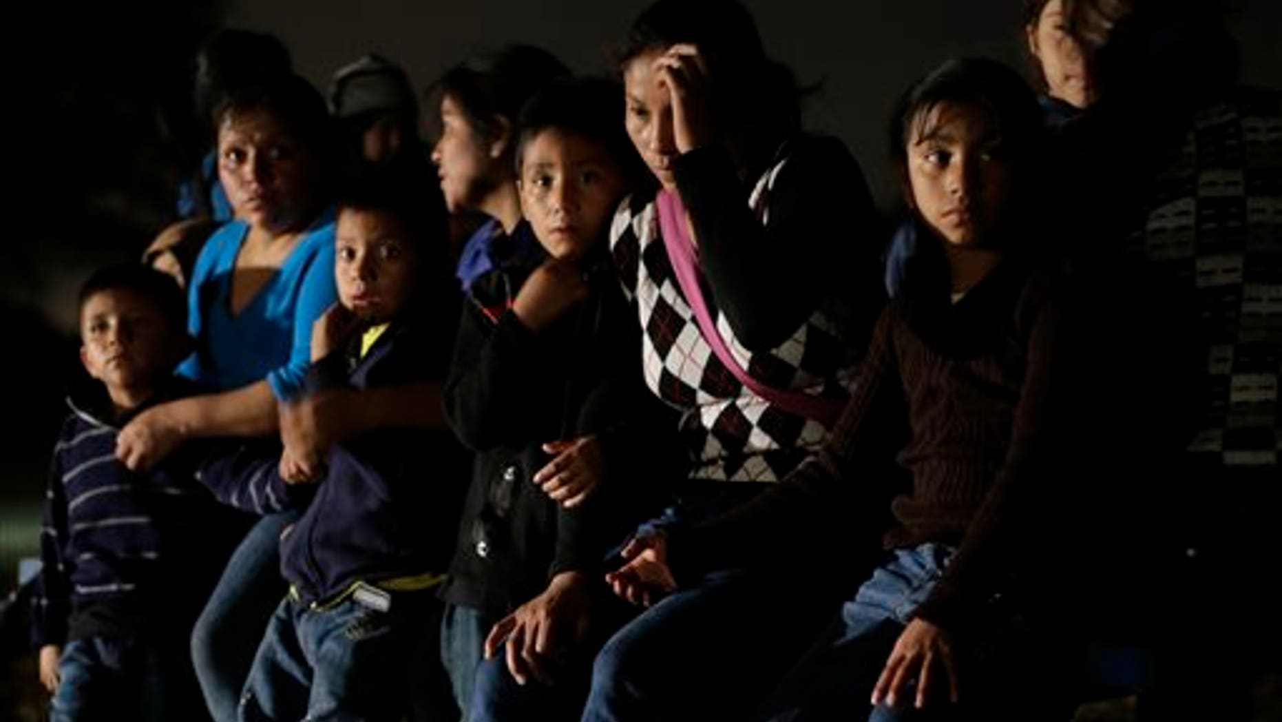 In this June 25, 2014 photo, a group of immigrants from Honduras and El Salvador who crossed the U.S.-Mexico border illegally are stopped in Granjeno, Texas. Just since October, the Border Patrols Rio Grande Valley sector has made more than 194,000 arrests, nearly triple that of any other sector. Most are from Central America, and many are children. (AP Photo/Eric Gay)