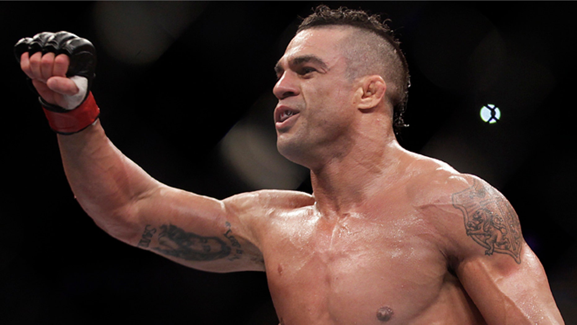 FILE - In this Jan. 20, 2013 file photo, Vitor Belfort, from Brazil, celebrates after defeating Michael Bisping during a middleweight mixed martial arts bout in Sao Paulo, Brazil. Belfort is scheduled to fight Chris Weidman in a middleweight title matchup on Saturday, May 23, 2015 at UFC 187. in Las Vegas,.(AP Photo/Andre Penner, File)