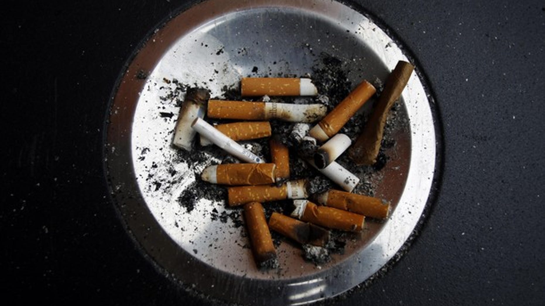 Cigarette butts are left in an ashtray at Atocha train station in Madrid January 1, 2011. A new Spanish anti-smoking law will take effect on January 2 that will prohibit smoking in all enclosed spaces as well outside hospitals, at playgrounds and schools. The Spanish Socialist government wants to put the country in line with the European Union's strictest anti-smoking nations. REUTERS/Susana Vera (SPAIN - Tags: SOCIETY POLITICS)