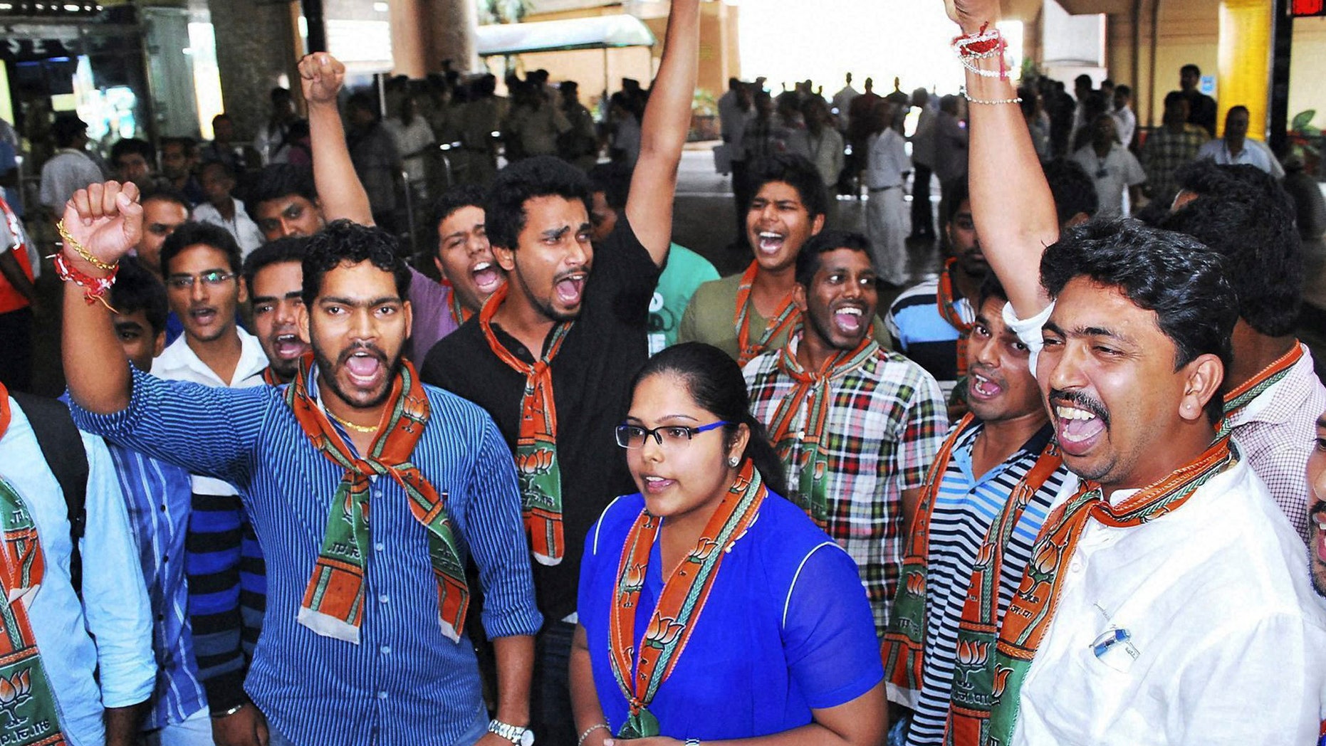 In this Friday, Nov. 29, 2013 photo, activists of the youth wing of India’s main opposition Bharatiya Janata Party shout slogans against Tarun Tejpal, editor of Tehelka magazine, ahead of his arrival at the airport in Panaji, India. The editor of the magazine known for exposing abuses of power has appeared in a court Saturday seeking bail to avoid arrest in a sexual assault case that has fueled fresh outrage over the treatment of women in India. (AP Photo)