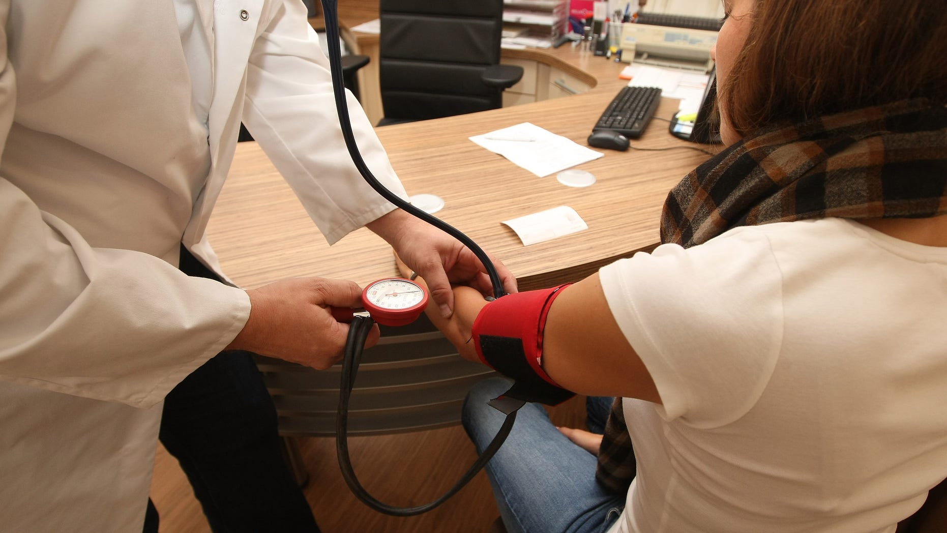 BERLIN, GERMANY - SEPTEMBER 05: A doctor checks a patient's blood pressure on September 5, 2012 in Berlin, Germany. Doctors in the country are demanding higher payments from health insurance companies (Krankenkassen). Over 20 doctors' associations are expected to hold a vote this week over possible strikes and temporary closings of their practices if assurances that a requested additional annual increase of 3.5 billion euros (4,390,475,550 USD) in payments are not provided. The Kassenaerztlichen Bundesvereinigung (KBV), the National Association of Statutory Health Insurance Physicians, unexpectedly broke off talks with the health insurance companies on Monday. (Photo by Adam Berry/Getty Images)
