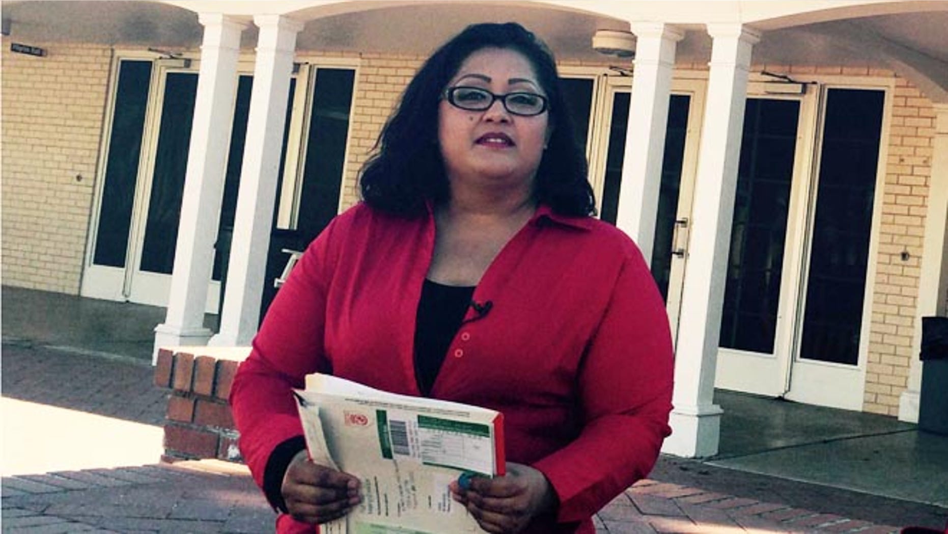 Nancy Perez, who qualifies for President Barack Obama's deportation relief plan, holds documents she was planning to use for her application for the program.