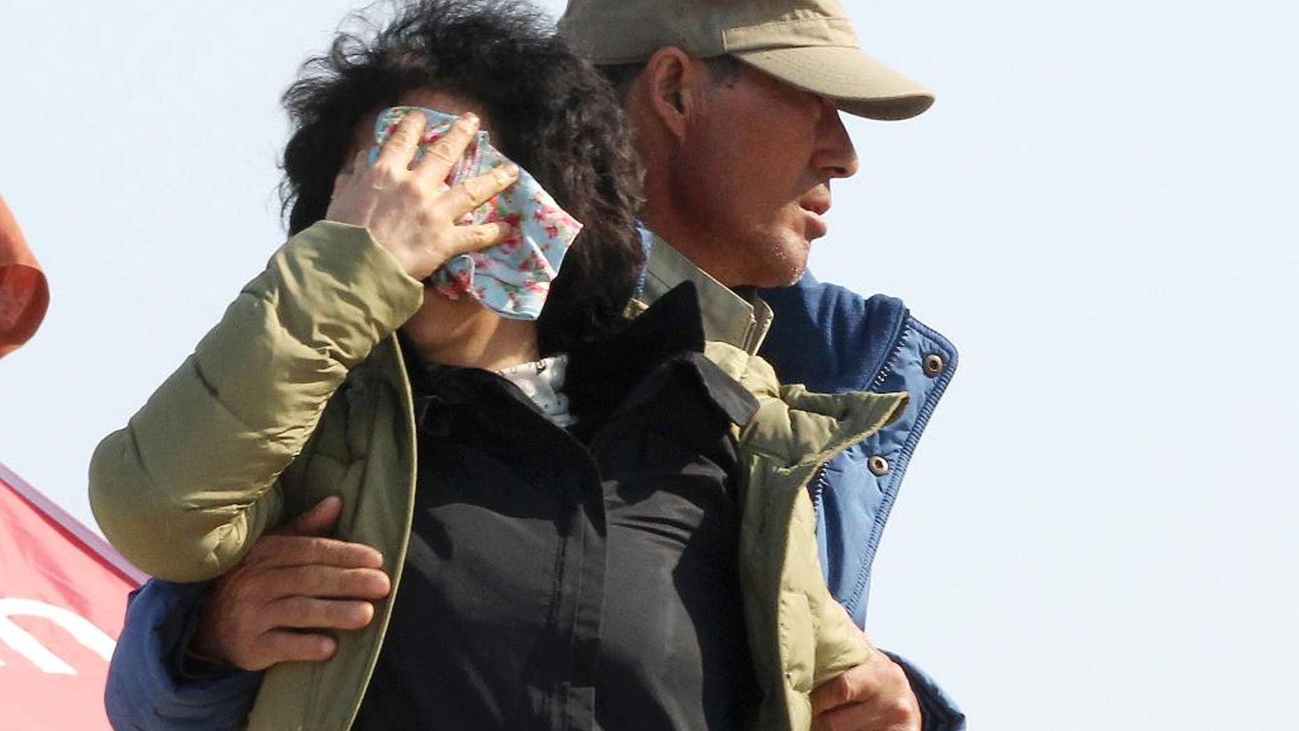 A relative of a passenger aboard the sunken ferry Sewol cries while waiting for her missing loved one at a port in Jindo, South Korea. (AP Photo/Ahn Young-joon)