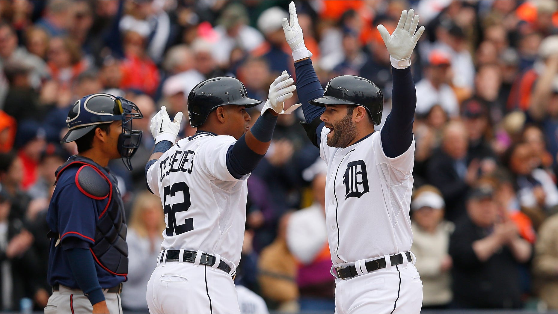 DETROIT, MI - APRIL 6: Alex Avila #13 of the Detroit Tigers celebrates with teammate Yoenis Cespedes #52 after hitting a two run home run in the second inning of the the Opening Day game against the Minnesota Twins at Comerica Park on April 6, 2015 in Detroit, Michigan. (Photo by Leon Halip/Getty Images)