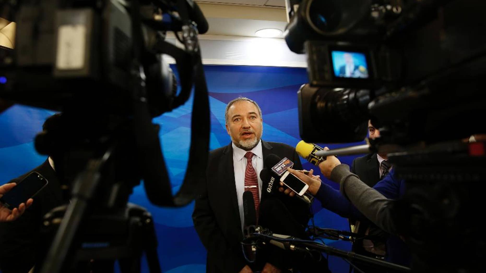 FILE - In this Dec. 28, 2014 file photo, Israel's Minister of Foreign Affairs Avigdor Lieberman, speaks to the media ahead of the weekly cabinet meeting in Jerusalem. A corruption investigation that has roped in 30 Israeli public figures and politicians linked to the Lieberman's Yisrael Beitenu party has shaken up the campaign ahead of March elections, throwing the hard-line party's future into disarray. (AP Photo/Gali Tibbon, File)