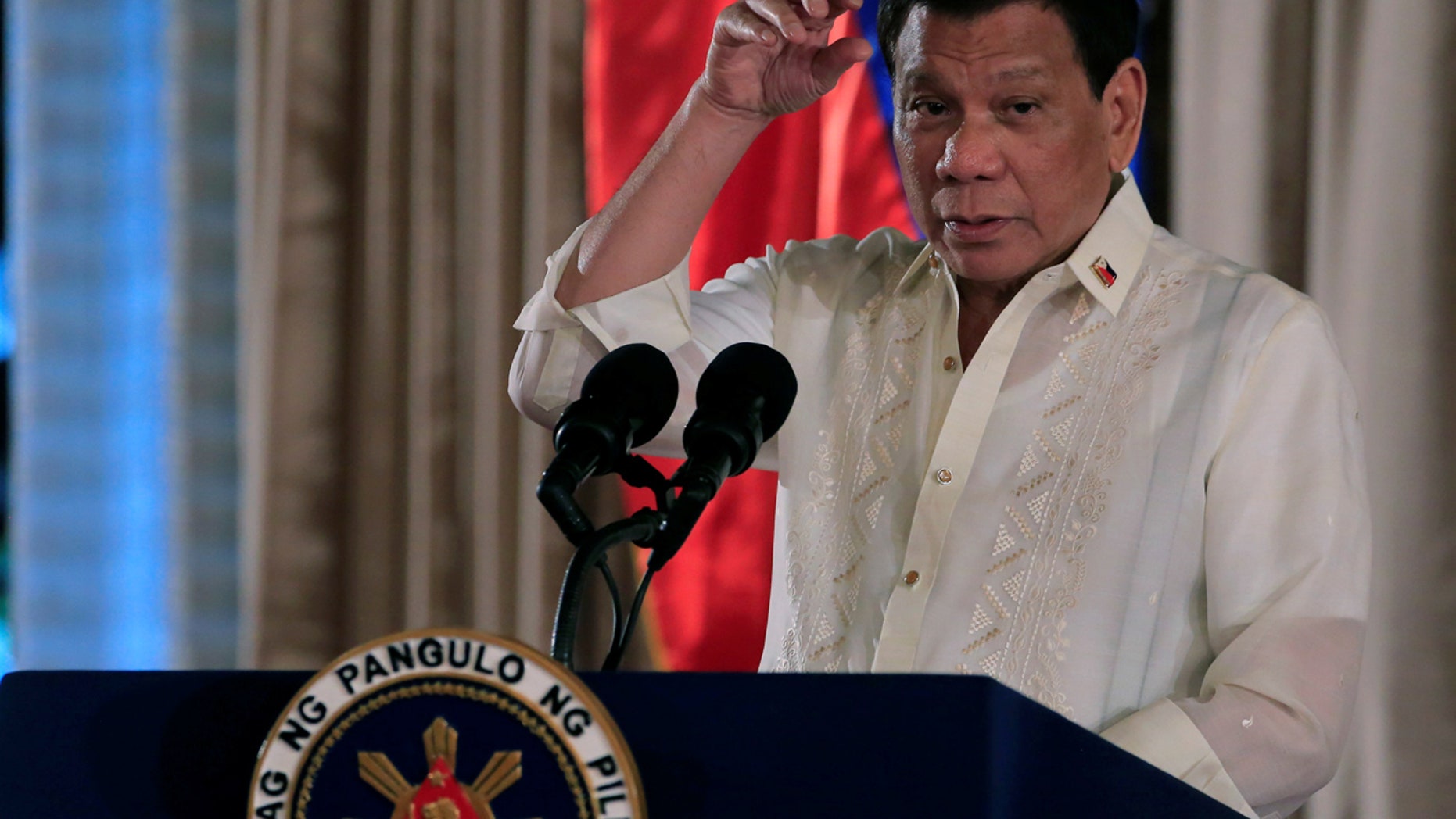 FILE: Philippine President Rodrigo Duterte gestures as he delivers his speech, during the oath taking of Philippine National Police