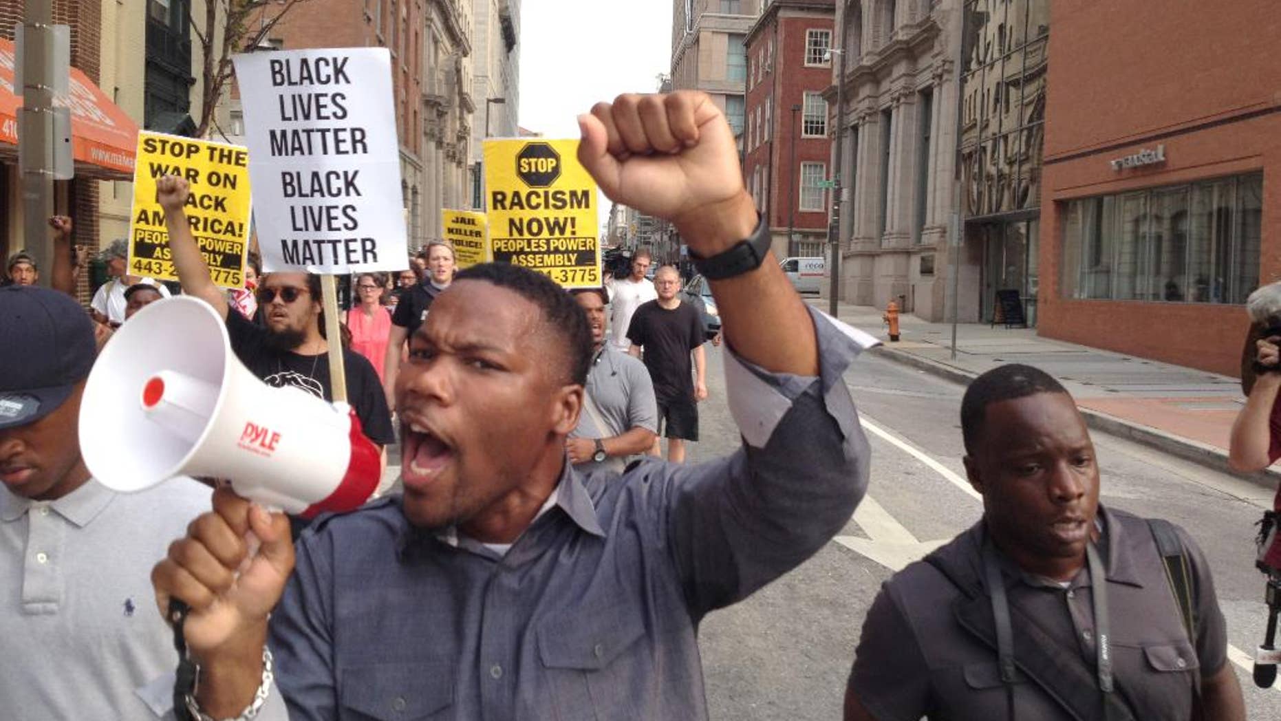 FILE - In a Wednesday, Sept. 2, 2015 file photo, Pastor Westley West, from Faith Empowered Ministries, leads protesters as they march towards Pratt Street and the Inner Harbor, in Baltimore, as the first court hearing was set to begin for six police officers criminally charged in the death of Freddie Gray. West was arrested Wednesday, Sept. 9, a week after police say he blocked traffic while protesting during pre-trial hearings in the Freddie Gray case. He is charged with attempting to incite a riot, malicious destruction of property, disorderly conduct, disturbance of the peace, false imprisonment and failure to obey. (Lloyd Fox/The Baltimore Sun via AP, File) WASHINGTON EXAMINER OUT; MANDATORY CREDIT