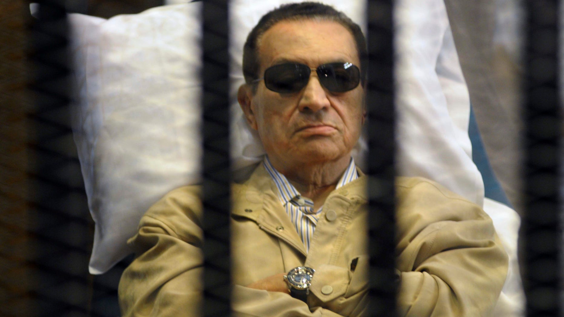 June 2, 2012: In this file photo, Egypt's ex-President Hosni Mubarak lays on a gurney inside a barred cage in the police academy courthouse in Cairo, Egypt.