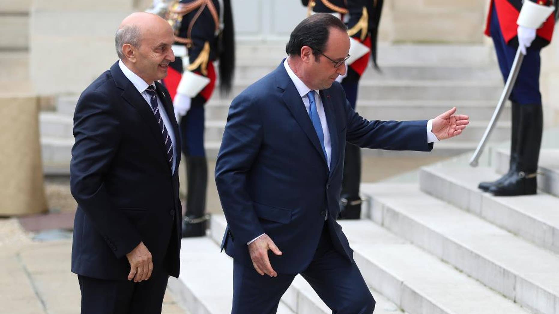France's President Francois Hollande, right, welcomes Prime Minister of Kosovo Isa Mustafa, prior to the Balkans summit, at the Elysee Palace, in Paris, Monday, July 4, 2016. The leaders of France, Germany, Italy and Balkan nations are meeting to better prevent extremists from sneaking in with migrants who are moving west across Europe. (AP Photo/Thibault Camus)