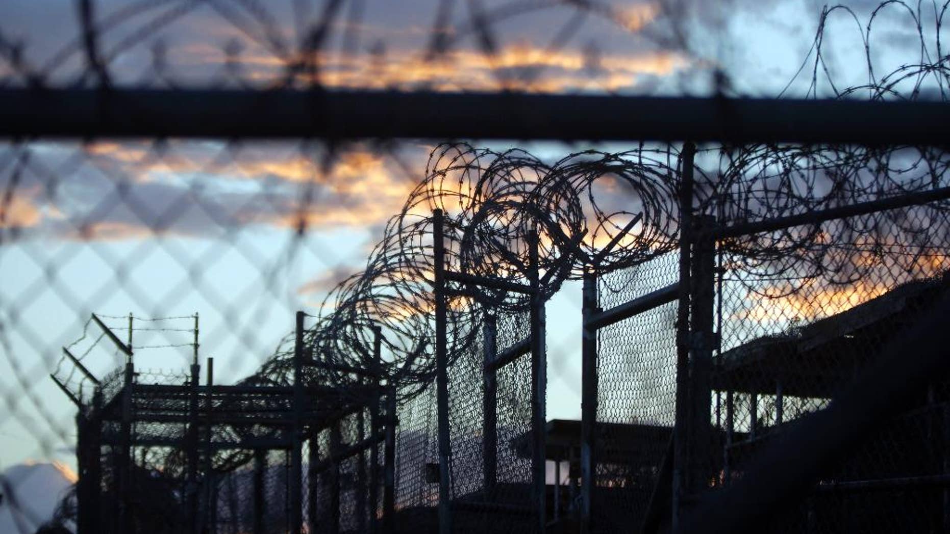 FILE - In this Nov. 21, 2013, file photo reviewed by the U.S. military, dawn arrives at the now closed Camp X-Ray, which was used as the first detention facility for al-Qaida and Taliban militants who were captured after the Sept. 11 attacks at Guantanamo Bay Naval Base, Cuba. The Defense Department is taking another look at the military prison in Kansas and the Navy Brig in South Carolina as it evaluates potential U.S. facilities to house detainees from the prison at Guantanamo Bay, Cuba, part of the Obama administration’s controversial push to close the detention center. (AP Photo/Charles Dharapak, File)