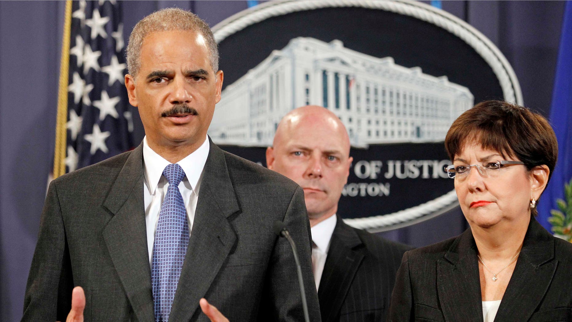 Attorney General Eric Holder, left, accompanied by US Attorney Rosa Emilia Rodriguez-Velez of the District of Puerto Rico, right, and FBI Executive Director Shawn Henry, answers questions during a news conference at the Justice Department in Washington, Wednesday, Oct. 6, 2010. (AP Photo/Haraz N. Ghanbari)