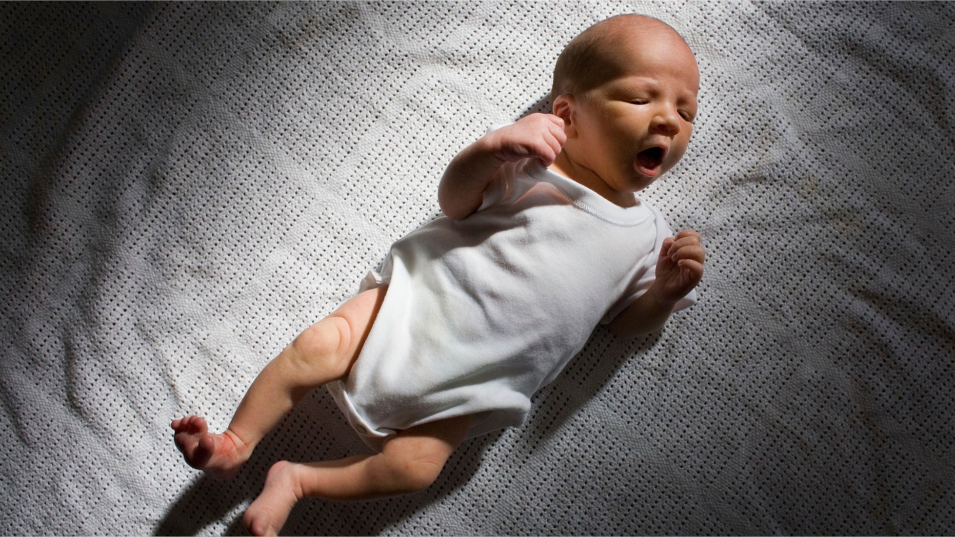 KNUTSFORD, UNITED KINGDOM - (FILE) In this file photograph taken in March 12, 2007, a two-week-old boy eyes his new world. Health Secretary Patricia Hewitt announnced, April 3, 2007 that for the first time, mothers-to-be will have a guarantee that the NHS will provide them with a full range of birthing choices - including home births - and a midwife they know and trust to care for them. (Photo by Christopher Furlong/Getty Images)