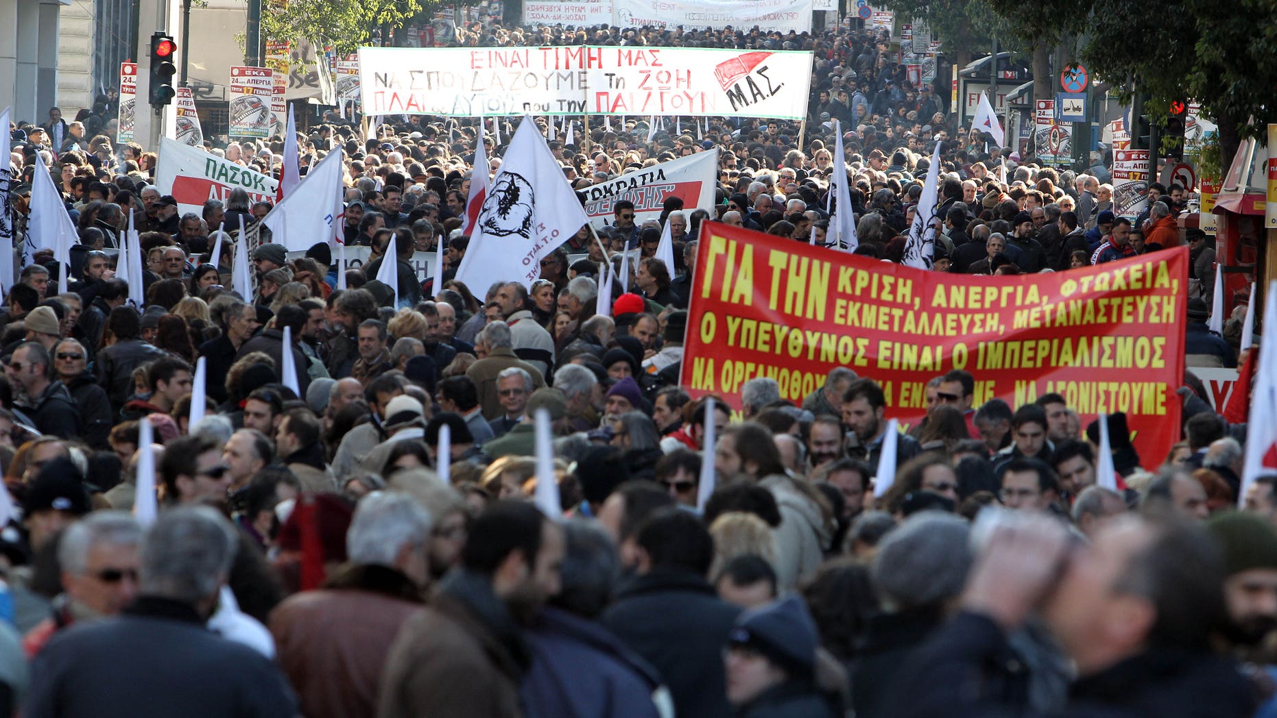 Jan. 17, 2012: Protesters take part in a rally organized by the PAME Communist-affiliated union as they hold banners with anti-austerity slogans in Athens.
