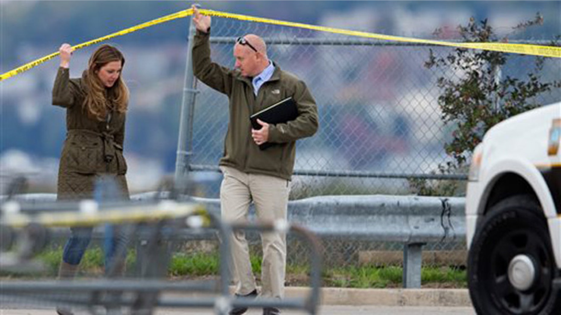 Luzerne County District Attorney Stefanie Salavantis, left, and investigator visit shooting scene outside a Walmart in Wilkes-Barre, Pa., Saturday.