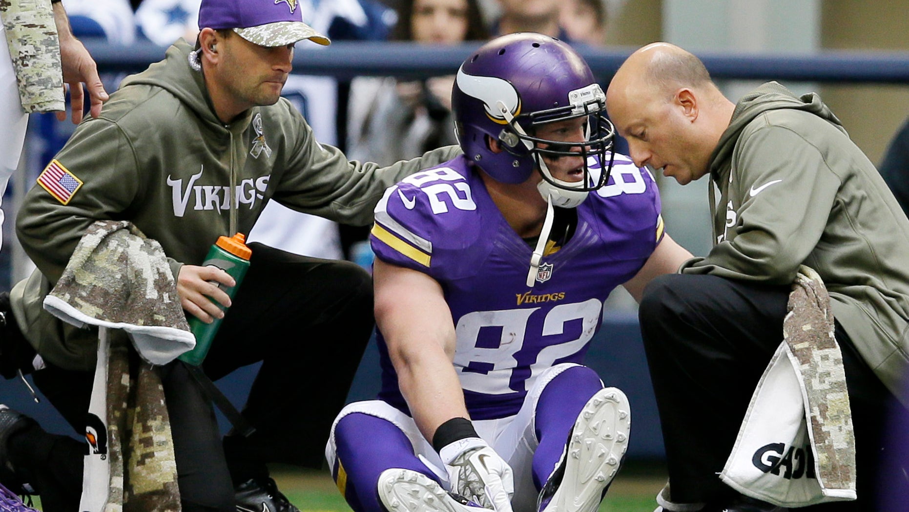 Minnesota Vikings' Kyle Rudolph (82) is attended to by staff after Rudolph scored on a pass play in the second half of an NFL football game against the Dallas Cowboys, Sunday, Nov. 3, 2013, in Arlington, Texas. (AP Photo/Tim Sharp)