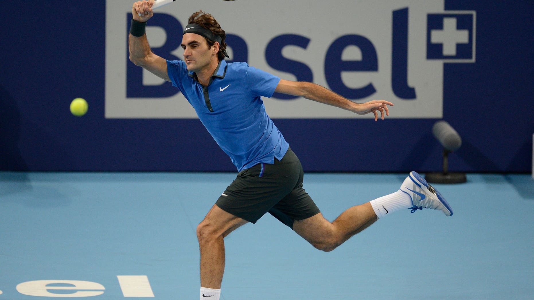 FILE - This is a Sunday, Oct. 28, 2012 file photo of Switzerland's Roger Federer as he returns a ball to Argentina's Juan Martin Del Potro during their final match at the Swiss Indoors tennis tournament at the St. Jakobshalle in Basel, Switzerland. Roger Federer says he will play at the Swiss Indoors in October, ending speculation he could skip his hometown tournament in a contractual dispute. Federer told the Swiss daily Tages Anzeiger on Wednesday April 10, 2013 that "everyone knows how much this tournament means to me, and that is still true." (AP Photo/Keystone/Georgios Kefalas, File)