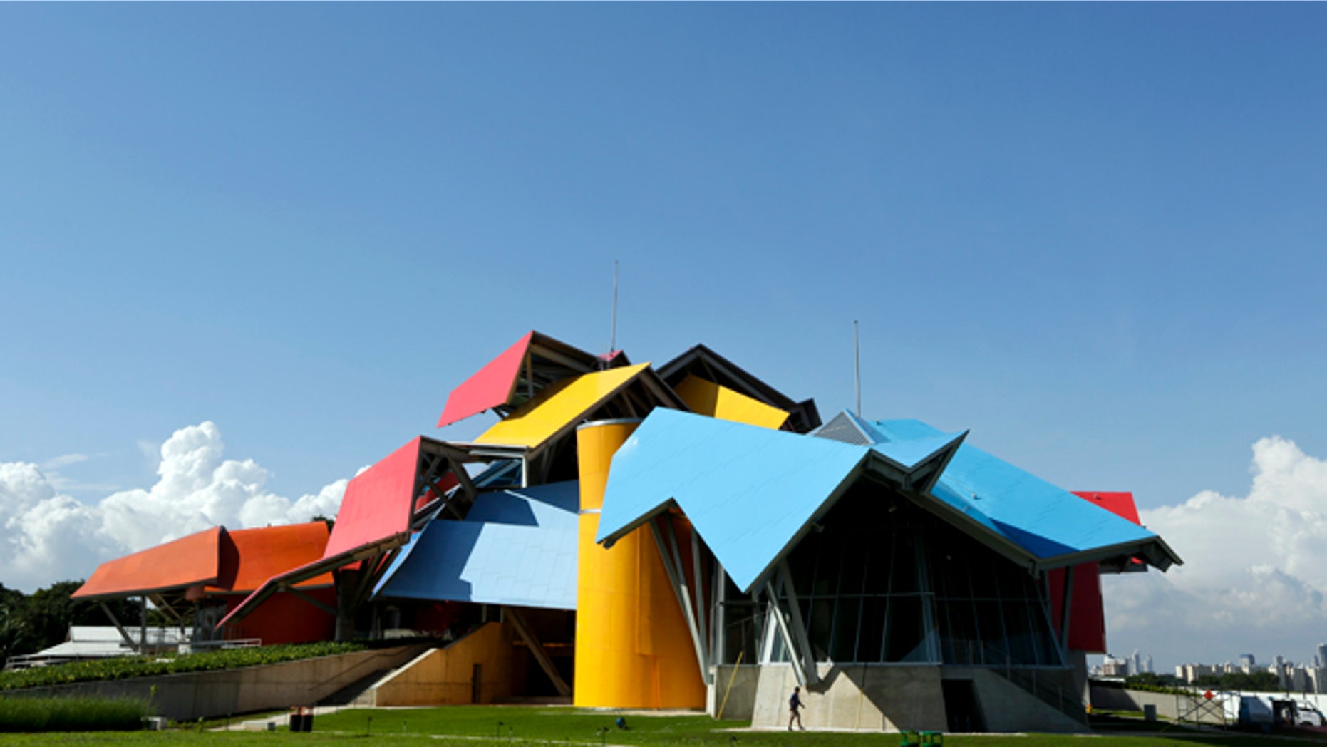 In this Saturday, Sept. 27, 2014 photo, a maintenance worker walks on the grounds of the Biomuseo, days before the museum's inauguration, in Panama City. After years of delays, Panama inaugurated Tuesday, Sept. 30, 2014, the museum, designed by world-renowned architect Frank Gehry. (AP Photo/Arnulfo Franco)