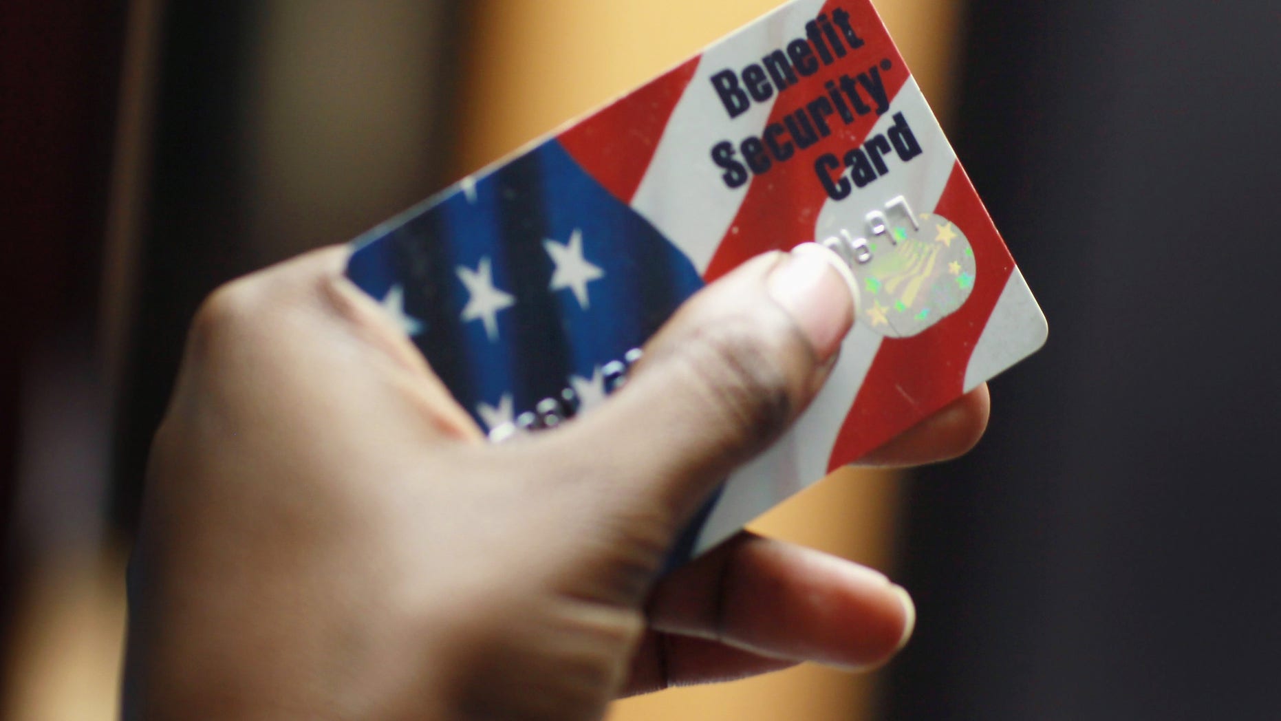 NEW YORK - FEBRUARY 10: Kethia Dorelus a social worker with the Cooperative Feeding Program displays a Federal food stamps card that is used to purchase food on February 10, 2011 in Fort Lauderdale, Florida. Recent statistics show that nationwide, one in seven Americans receives help from the Federal government with buying food. The food stamp program was used by 43.6 million people in November 2010. Before the recession, the program was serving 26 million. (Photo by Joe Raedle/Getty Images)