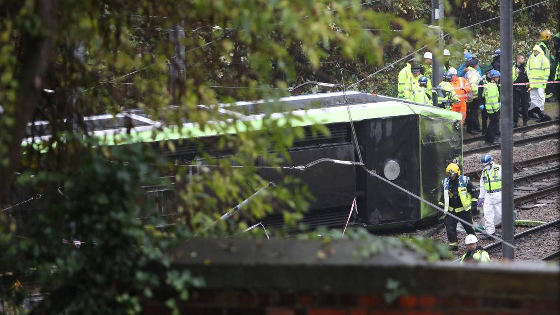 FILE - In this Nov. 9, 2016 file photo, the scene after a tram overturned in Croydon, south London. Investigators have determined that a London tram that crashed last week, killing seven people, was traveling at nearly four times the speed limit when it derailed. (Steve Parsons/PA, AP, File)