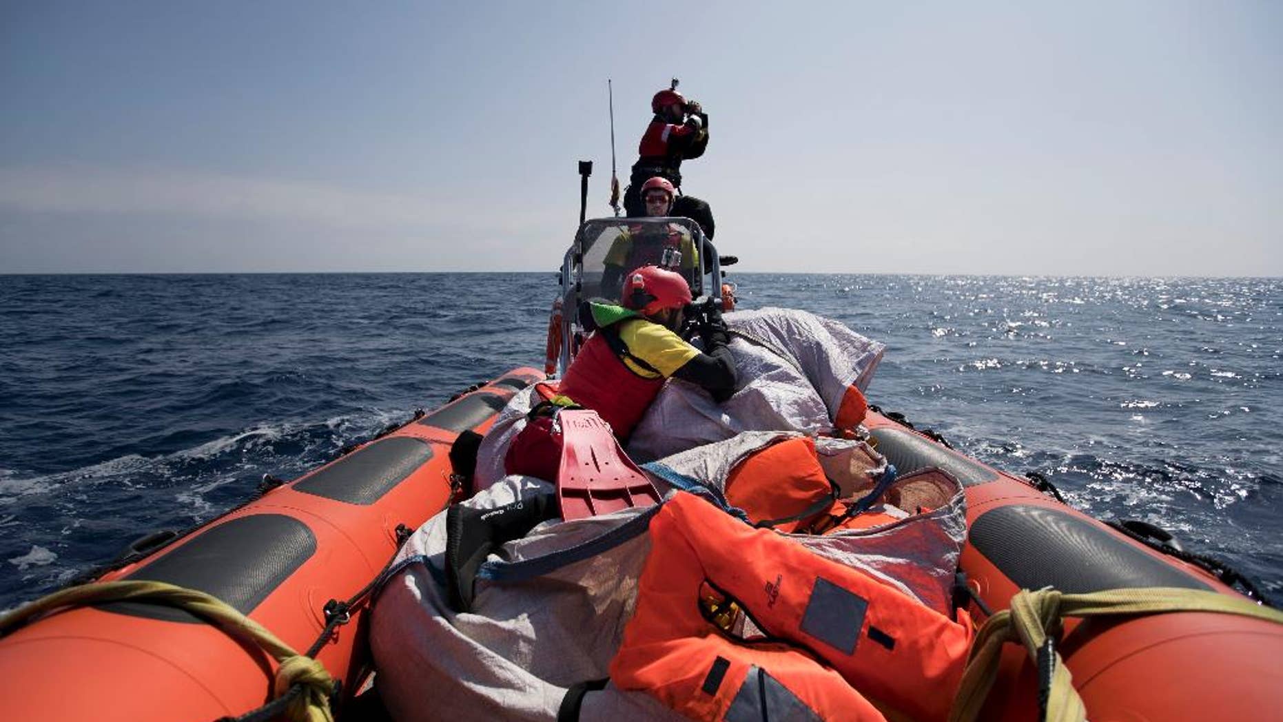 Proactiva Open Arms crew conduct a search and rescue operation in the Mediterranean sea, 12 nautic miles from the Libyan coast, Thursday, April 13, 2017. The Libyan coast guard says 97 migrants are missing and believed drowned after their Europe-bound boat sank on a perilous crossing of the Mediterranean Sea. (AP Photo/Bernat Armangue)